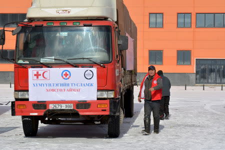 Red cross workers prepare to send trucks to deliver food and monetary aid to eight provinces over Mongolia's vast steppe, mountains and frozen rivers from Ulan Bator, Mongolia, February 26, 2016. Global aid agencies are responding to a call for assistance by Mongolia as harsh winter weather raises fears for the safety and livelihoods of the country's traditional pastoralists, who have already been hit hard by a drought last year. Picture taken February 26, 2016. REUTERS/Terrence Edwards EDITORIAL USE ONLY. NO RESALES. NO ARCHIVE