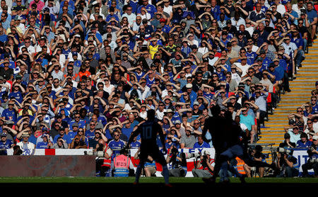 FILE PHOTO: FA Cup Final - Chelsea vs Manchester United - Wembley Stadium, London, Britain - May 19, 2018 Chelsea fans shield their eyes from the sun during the match REUTERS/Andrew Yates/File Photo