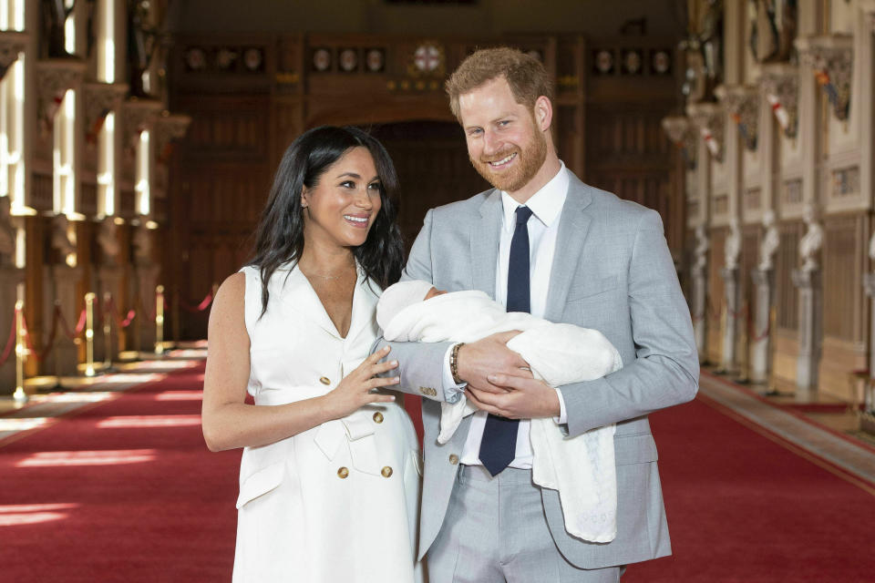 Britain's Prince Harry and Meghan, Duchess of Sussex, during a photocall with their newborn son, in St George's Hall at Windsor Castle, Windsor, south England, Wednesday May 8, 2019. Baby Sussex was born Monday at 5:26 a.m. (0426 GMT; 12:26 a.m. EDT) at an as-yet-undisclosed location. An overjoyed Harry said he and Meghan are "thinking" about names. (Dominic Lipinski/Pool via AP)