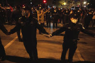 Chinese policemen form a line to stop protesters marching in Beijing, Sunday, Nov. 27, 2022. Protesters angered by strict anti-virus measures called for China's powerful leader to resign, an unprecedented rebuke as authorities in at least eight cities struggled to suppress demonstrations Sunday that represent a rare direct challenge to the ruling Communist Party. (AP Photo/Ng Han Guan)