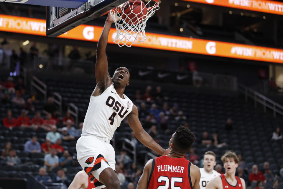 Oregon State's Alfred Hollins (4) dunks against Utah during the first half of an NCAA college basketball game in the first round of the Pac-12 men's tournament Wednesday, March 11, 2020, in Las Vegas. (AP Photo/John Locher)