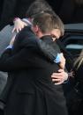 NEWTOWN, CT - DECEMBER 18: Family and friends embrace after the funeral for shooting victim Jessica Rekos, 6, at the St. Rose of Lima Catholic church on December 18, 2012 in Newtown, Connecticut. Funeral services were held at the church for both Jessica Rekos and James Mattioli, 6, Tuesday, four days after 20 children and six adults were killed at Sandy Hook Elementary School. (Photo by John Moore/Getty Images)