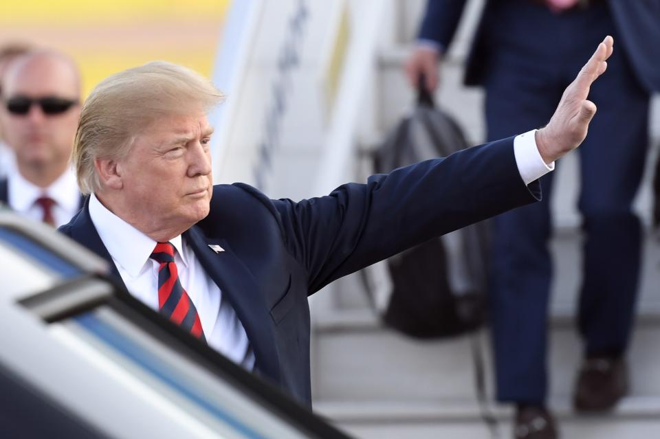 <p>U.S. President Donald Trump waves upon arrival at Helsinki-Vantaa Airport in Helsinki, on July 15, 2018 on the eve of a summit in Helsinki between the US President and his Russian counterpart. (Photo: Heikki Saukkomaa/AFP/Getty Images) </p>