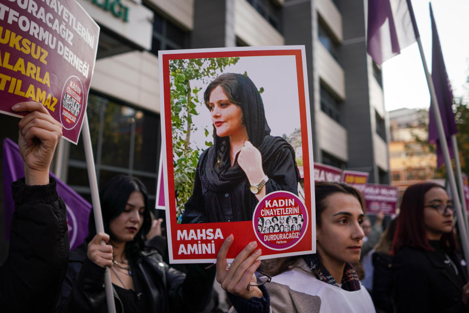 A protester holds a picture of Mahsa Amini, who was killed by the morality police in Iran during the demonstration. (Photo by Tunahan Turhan/SOPA Images/LightRocket via Getty Images)