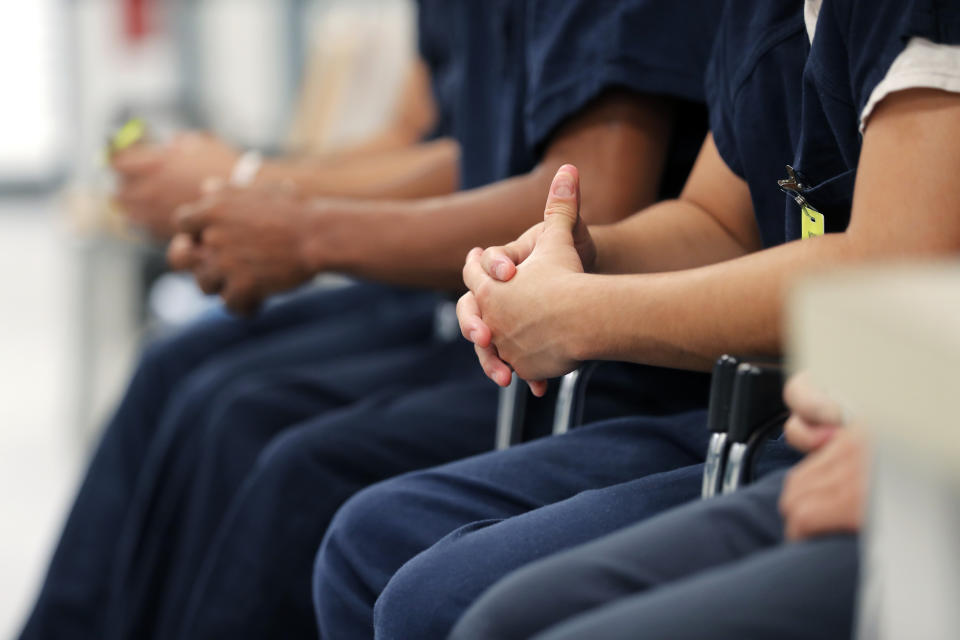 Detainees sit and wait for their turn at the medical clinic at the Winn Correctional Center in Winnfield, La., Thursday, Sept. 26, 2019. Nearly 1,500 migrants are detained at Winn. (AP Photo/Gerald Herbert)