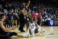 Villanova's Eric Dixon, right, reacts after being fouled by Pennsylvania's Michael Wang during the first half of an NCAA college basketball game, Wednesday, Dec. 1, 2021, in Philadelphia. (AP Photo/Matt Slocum)