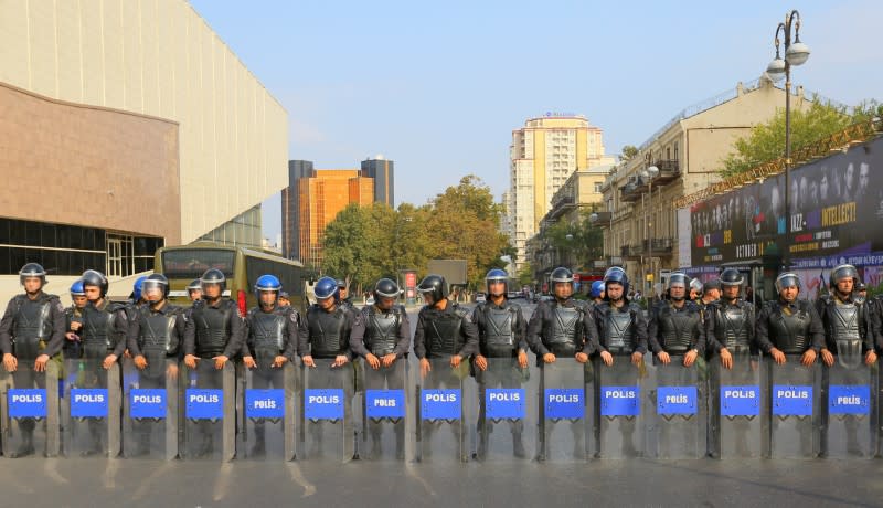 Azerbaijani law enforcement officers stand guard during an opposition rally in Baku