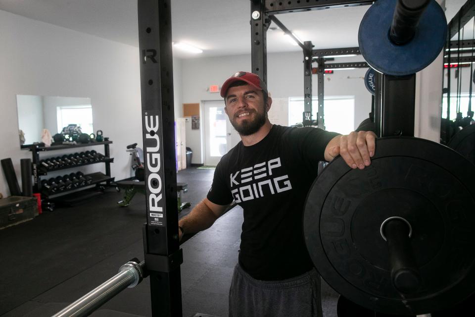 Fitness Trainer Ben Williams stands inside of his new gym, 1:1 Training Fuel Gym, on May 6, 2024, in Carroll, Ohio.