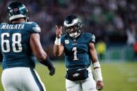 Philadelphia Eagles quarterback Jalen Hurts (1) reacts to his touchdown pass to Eagles' A.J. Brown (11) during the second half of an NFL football game against the Dallas Cowboys on Sunday, Nov. 5, 2023, in Philadelphia. (AP Photo/Chris Szagola)