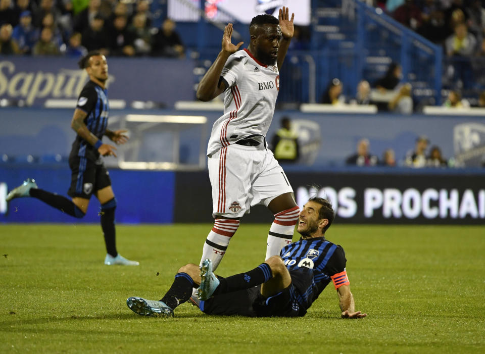 Sep 18, 2019; Montreal, Quebec, Canada; Montreal Impact midfielder Ignacio Piatti (10) collides with Toronto FC forward Jozy Altidore (17) during the second half in the Canadian Championship final at Stade Saputo. Mandatory Credit: Eric Bolte-USA TODAY Sports