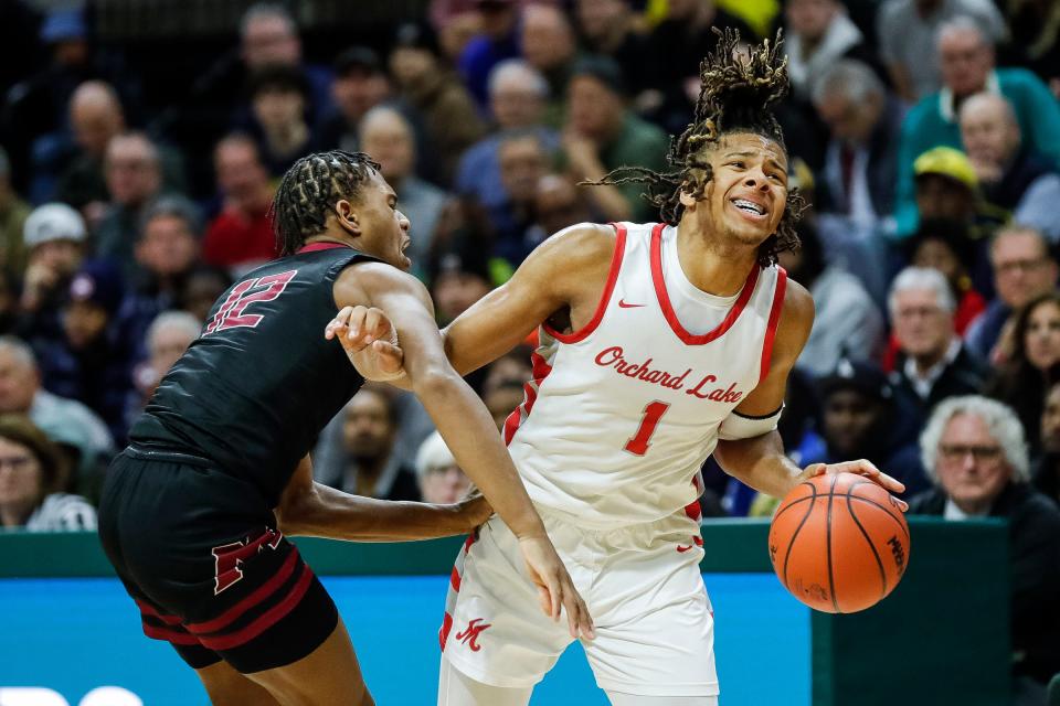 Orchard Lake St. Mary's guard Trey McKenney (1) dribbles against Muskegon guard James Martin (12) during the first half of MHSAA boys Division 1 semifinal at Breslin Center in East Lansing on Friday, March 24, 2023.