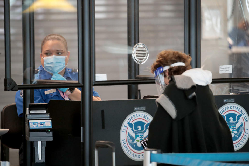 A Transportation Security Administration (TSA) agent screens an airline passenger at O'Hare International Airport in Chicago on October 19. Source: Getty