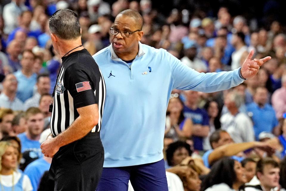 North Carolina coach Hubert Davis checks with official Roger Ayers during the Tar Heels’ defeat of Duke in the Final Four at Caesars Superdome in New Orleans.