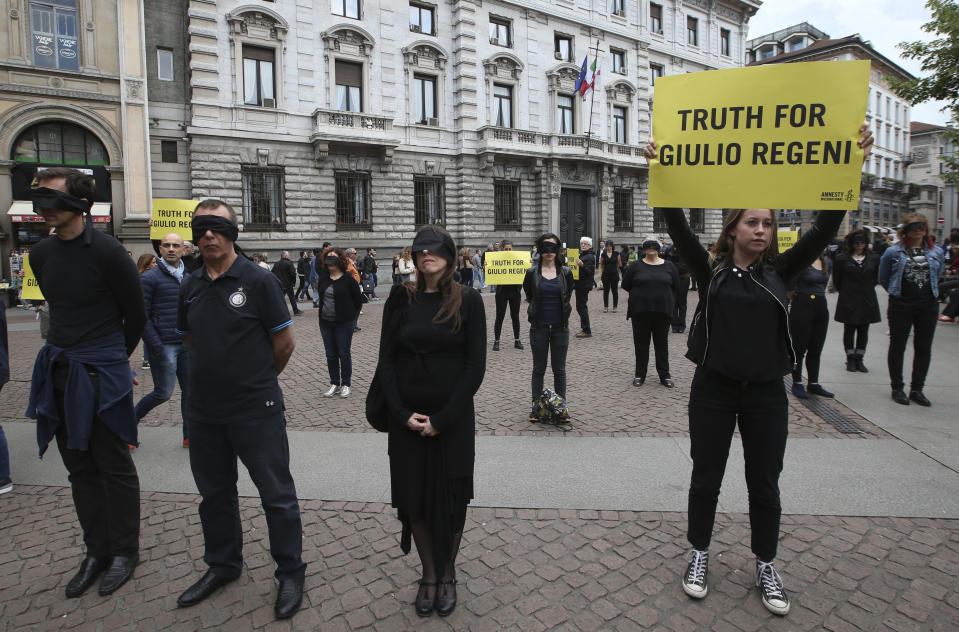 FILE - In this April 24, 2016 file photo, Amnesty International activists stage a flash mob asking for truth on the death in Egypt of Italian student Giulio Regeni, in front of Milan's city hall, Italy. Italian prosecutors on Thursday, Dec. 10, 2020 formally put three high-ranking members of Egypt’s national security force and one police officer under investigation in the 2016 kidnapping, torture and killing of an Italian youth doing doctoral research in Cairo. (AP Photo/Luca Bruno, file)