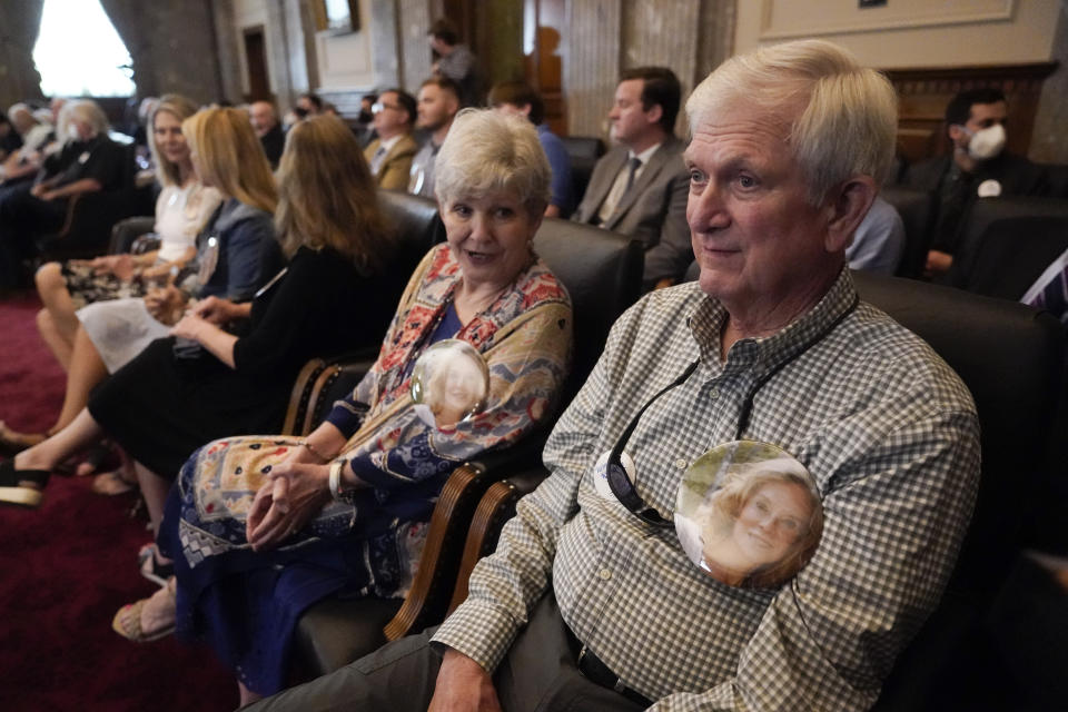 RETRANSMISSION TO CHANGE NAME TO JEAN NANCE - Michael Dunn, right, of Maryville, Tenn., wears a button with a photo of his late sister, Jean Nance, as he attends a Tennessee Supreme Court hearing Wednesday, June 1, 2022, in Nashville, Tenn. Vance, who was retired from working for the Tennessee Valley Authority, was called back to work at the TVA's Kingston Fossil Plant after a coal ash spill in 2008. Vance died in 2015 of leukemia. The court heard arguments that can determine whether workers at the plant have legal recourse to sue for damages they say were caused by their exposure to coal ash after the 2008 spill. (AP Photo/Mark Humphrey)