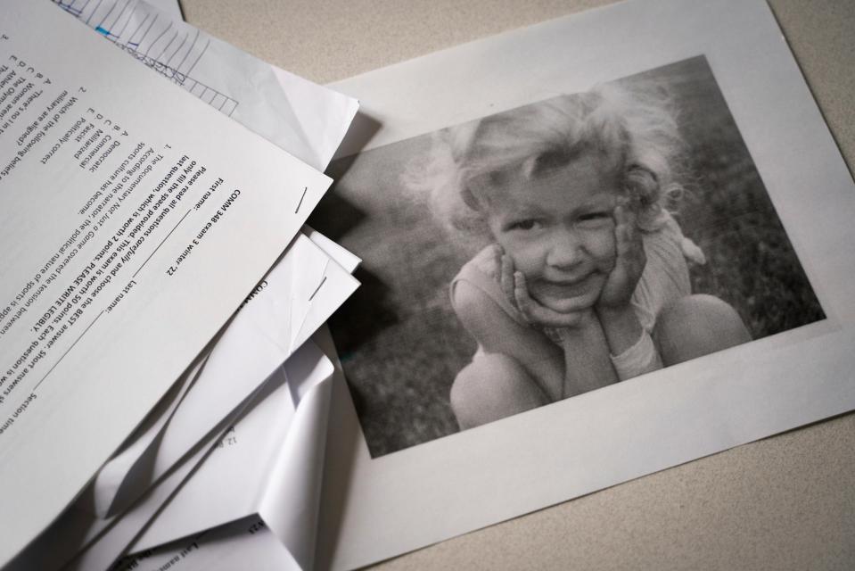 A childhood photograph of Kris Harrison around the age of 4, sits on the desk inside her office at the University of Michigan in Ann Arbor on Monday, April 3, 2023. "I got it drilled in my head from a very young age that, 'Oh, you're too sensitive, you're being a prima donna, you don't have a right to ask for accommodation, you need to shape shift yourself to the way the world is.' I think some of that is generational," said Harrison, who was officially diagnosed in her 40s with Asperger's syndrome, which is now part of a broader category called autism spectrum disorder (ASD). "It was just, 'Oh, she's a weird kid. She's a tomboy.' Nobody would have ever said autism at that time."