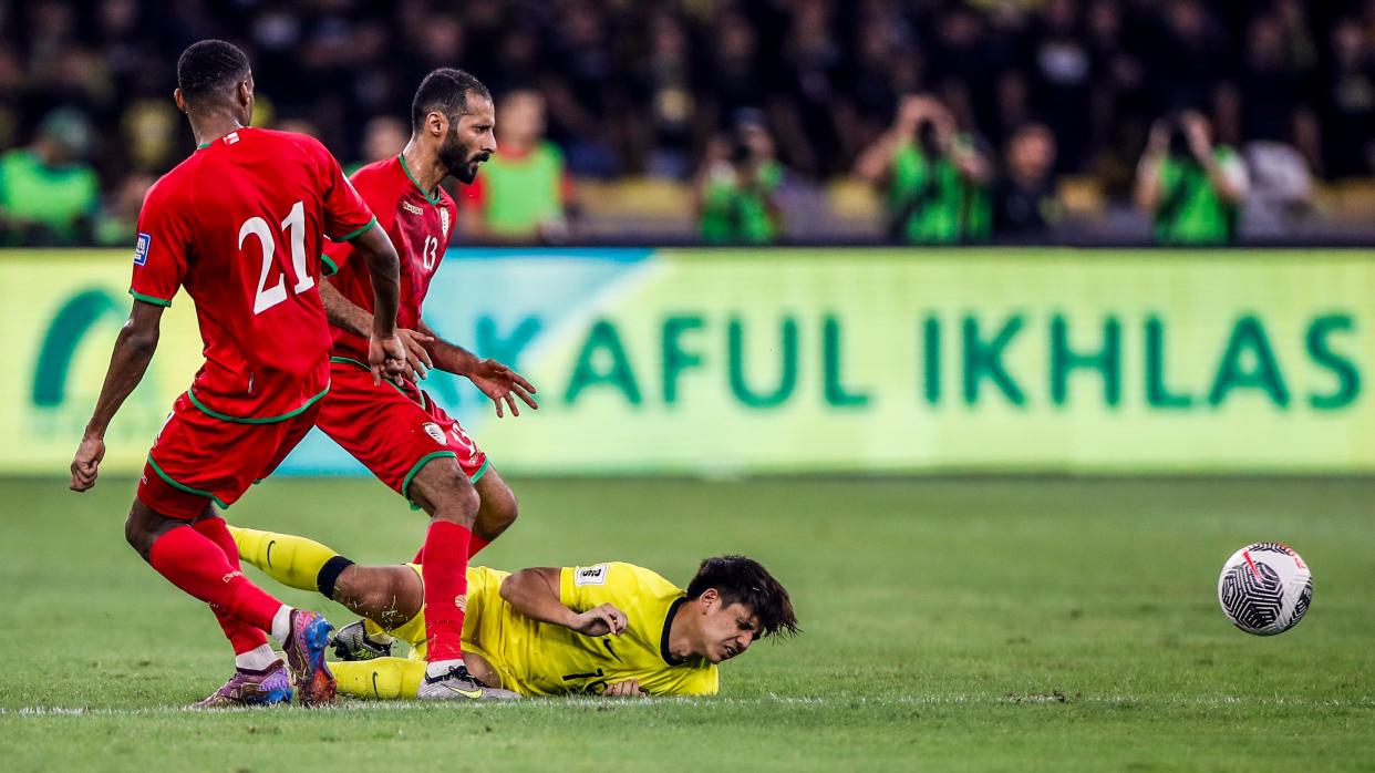 Oman's Abdul Rahman Al Mushaifri (left) and Abdul Aziz Al Shamousi, as well as Malaysia's Akhyar Rashid (yellow jersey) in action during their 2026 FIFA World Cup qualifier at the Bukit Jalil Stadium.