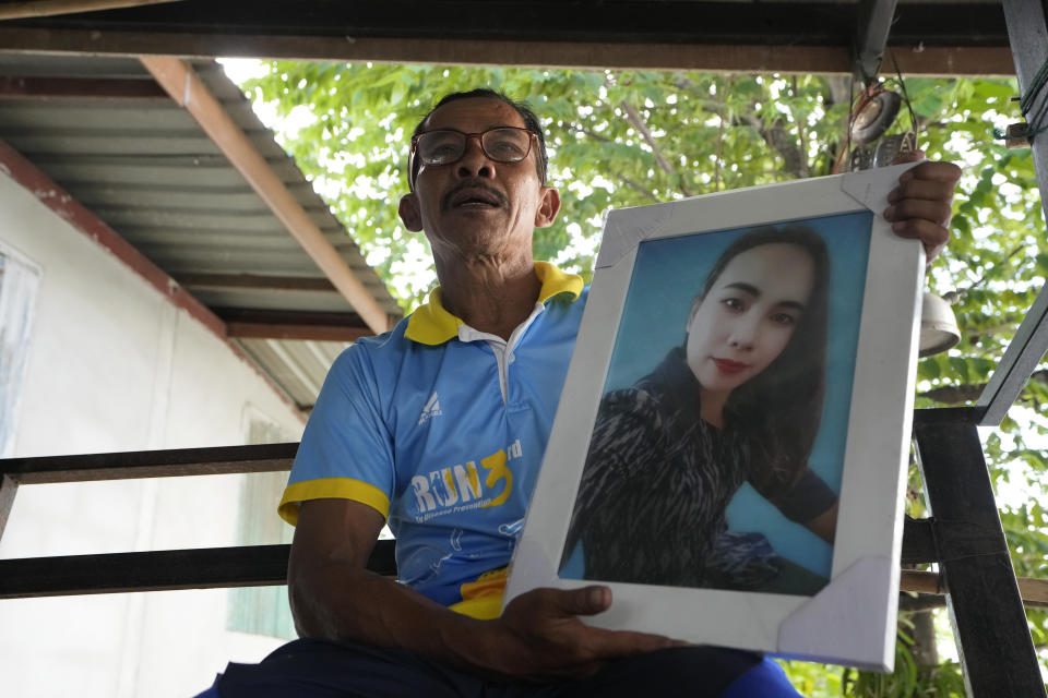 Tawee Lasopha holds a portrait of his daughter Maliwan Lasopha who was killed in a knife and gun attack at The Young Children's Development Center, as he talks during an interview in the rural town of Uthai Sawan, in Nong Bua Lamphu province, northeastern Thailand, Wednesday, Oct. 4, 2023. On Friday, Oct. 6, Tawee marks the first anniversary of the death of his daughter Maliwan Lasopha. (AP Photo/Sakchai Lalit)