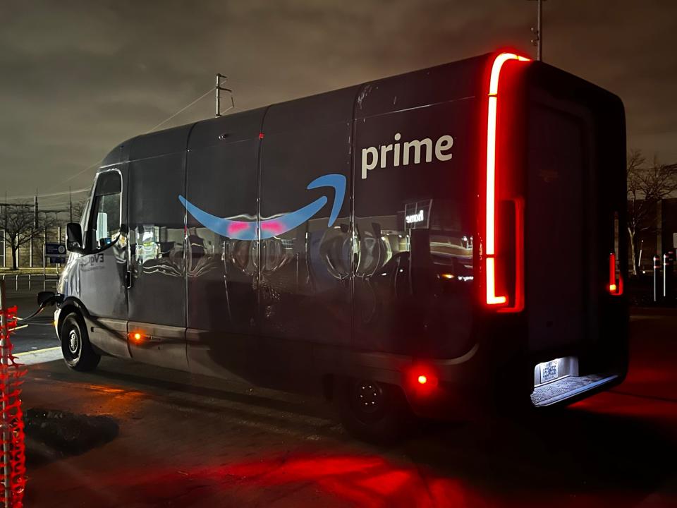 Rivian-built Amazon electric delivery vehicle stopped for charging during testing on Detroit-area roads.