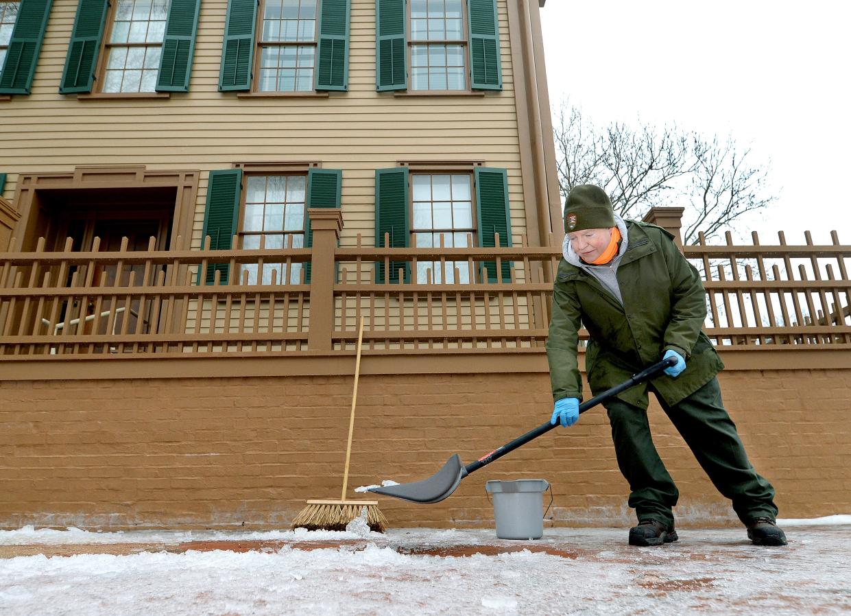 Maintenance worker Mark Detgen of the National Park Service at the Lincoln Home National Historic site clears a path in the ice in front of the Lincoln home Tuesday, January 23, 2024.