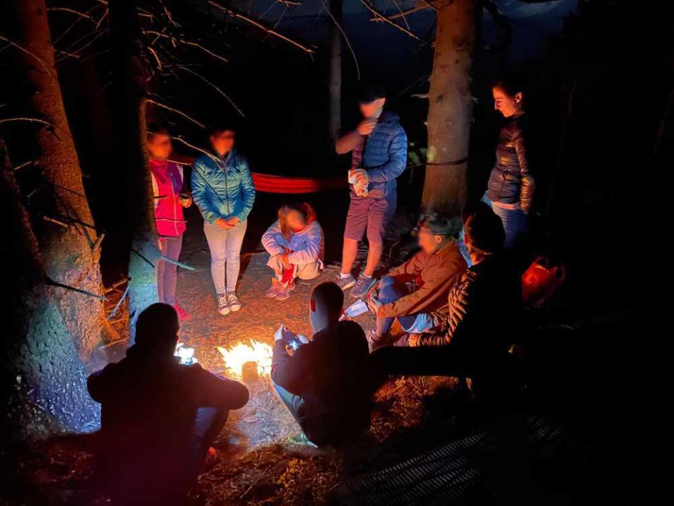 Lidiia (right) by the campfire with her friends moments before the tragedy (PA Real Life)