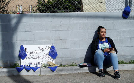 Sadiha Ramirez, 17, sits by a makeshift memorial for Grammy-nominated rapper Nipsey Hussle who was shot and killed outside his clothing store in Los Angeles, California, U.S., April 1, 2019. REUTERS/Mario Anzuoni