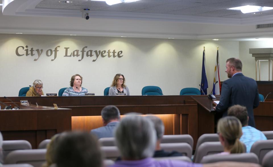 Cindy Murray, Lafayette City Clerk, and Lauren Ahlersmeyer, Lafayette City Councilwoman, listen to Ryan Munden, an attorney with Reiling Teder & Schrier and the legal representative for the Carr Family Farm II LLC explain why the board should approve the voluntary annexation of the Carr family property into the City of Lafayette, at July's Lafayette City Council meeting, on Monday, July 10, 2023, in Lafayette, Ind.