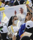 People wait for Pope Francis to celebrate mass at the Franso Hariri Stadium in Irbil, Kurdistan Region of Iraq, Sunday, March 7, 2021. The Vatican and the pope have frequently insisted on the need to preserve Iraq's ancient Christian communities and create the security, economic and social conditions for those who have left to return.(AP Photo/Andrew Medichini)