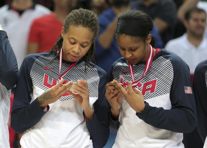 In this photo taken on Sunday, Oct. 5, 2014, U.S. basketball players Seimone Augustus, left, and Maya Moore look at their gold medals following their victory over Spain in the final of the women&#39;s Basketball Championship at Fenerbahce Arena in Istanbul, Turkey. (AP Photo)