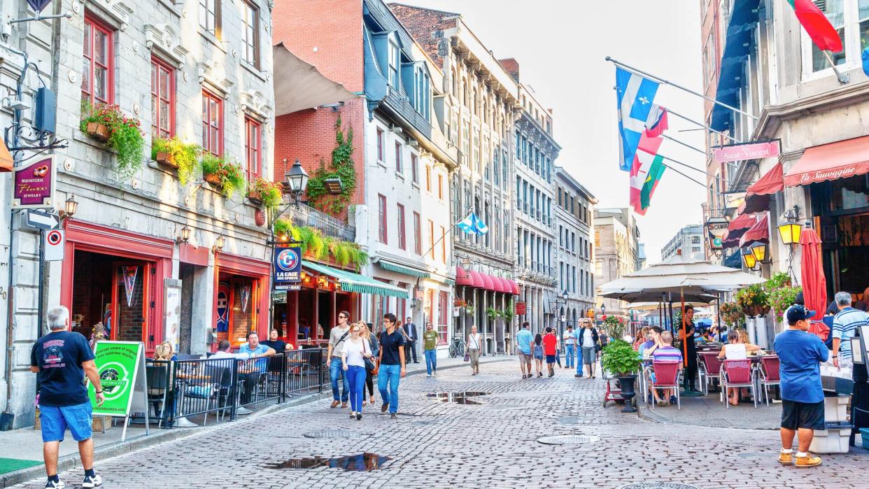 People meander at the junction of Rue Saint-Paul and Rue Saint-Vincent in the Old Montreal section of Montreal.