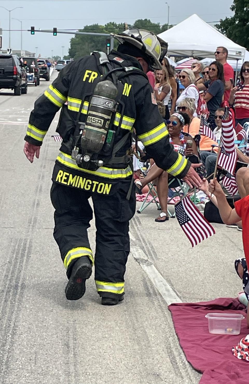 Franklin Fire Chief Adam Remington walks in a parade.