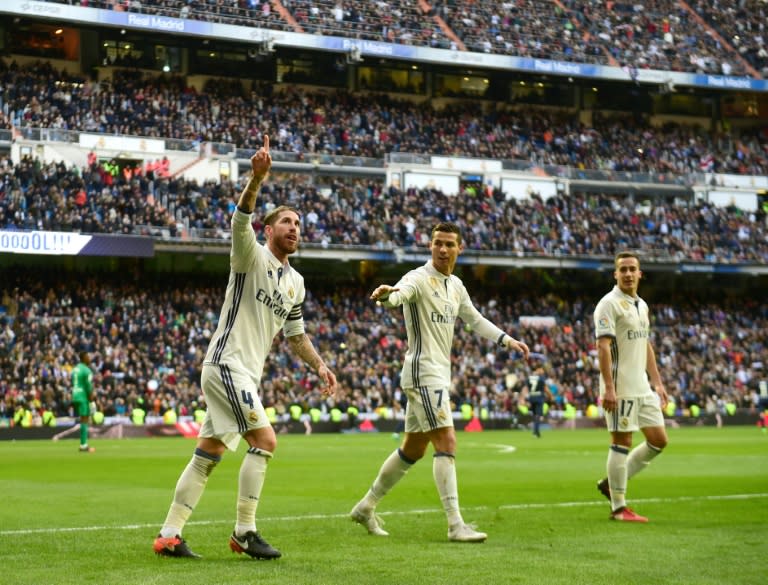 Real Madrid's Sergio Ramos (L) celebrates after scoring a goal during their Spanish La Liga match against Malaga, at the Santiago Bernabeu stadium in Madrid, on January 21, 2017