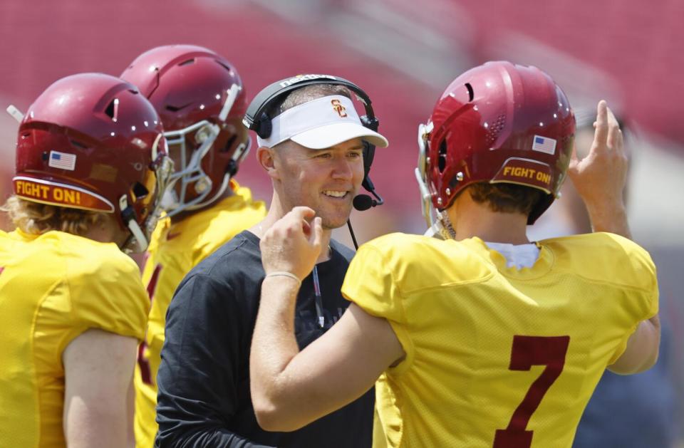 USC coach Lincoln Riley talks with quarterback Miller Moss (7) during the Trojans' spring game on April 20.