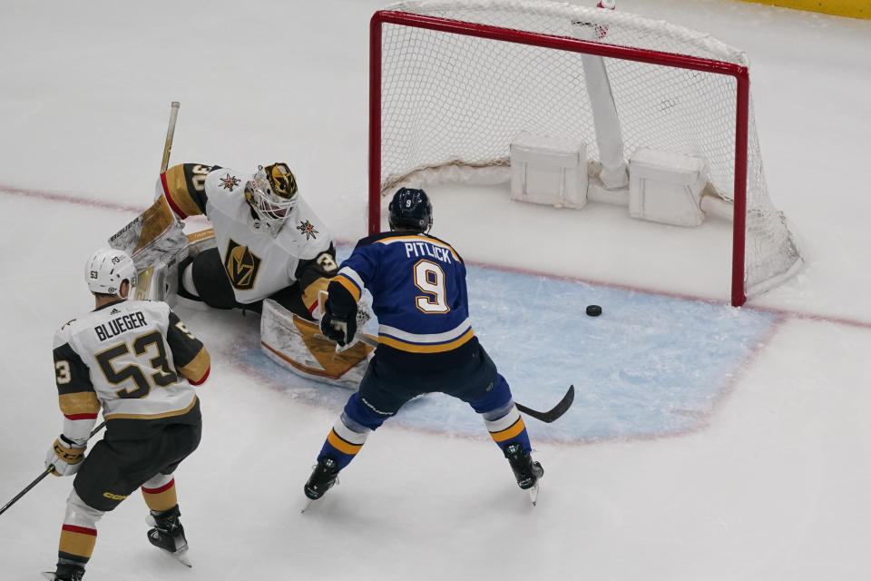 St. Louis Blues' Tyler Pitlick (9) scores past Vegas Golden Knights goaltender Jiri Patera as Golden Knights' Teddy Blueger (53) watches during the third period of an NHL hockey game Sunday, March 12, 2023, in St. Louis. (AP Photo/Jeff Roberson)