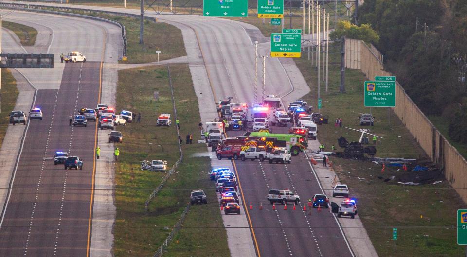 Emergency officials work the scene of plane crash on I-75 in Naples near exit 105 on Friday, Feb. 9, 2024. Two people were confirmed dead.