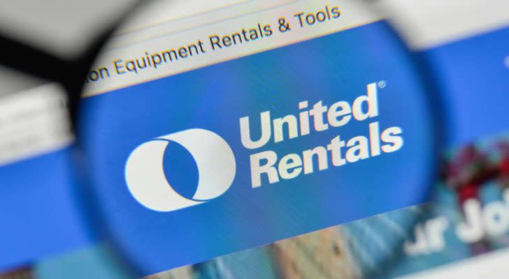 A magnifying glass zooms in on the website for United Rentals (URI).