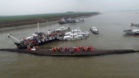 An aerial view shows rescue workers searching on the sunken ship at Jianli section of Yangtze River, Hubei province, China, June 2, 2015. REUTERS/Stringer