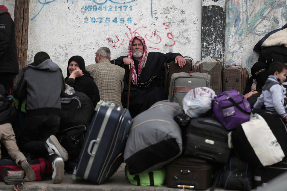 <p>Palestinians sit with their luggage as they wait to enter the Rafah border crossing with Egypt, in the southern Gaza Strip, Thursday, Feb, 8, 2018. (Photo: Khalil Hamra/AP) </p>