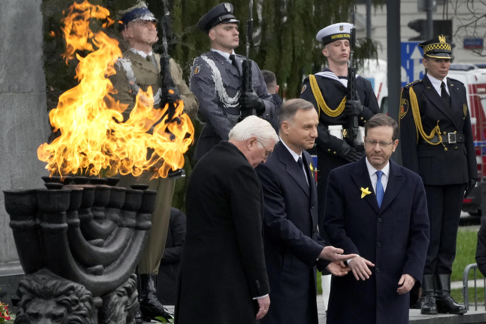 Front from right, Israel's President Isaac Herzog, Polish President Andrzej Duda and German President Frank-Walter Steinmeier attend a wreath-laying ceremony as part of a 'Warsaw Ghetto Uprising' commemoration reception in Warsaw, Poland, Wednesday, April 19, 2023. Presidents and Holocaust survivors and their descendants are marking the 80th anniversary of the Warsaw Ghetto Uprising. The anniversary honors the hundreds of young Jews who took up arms in Warsaw in 1943 against the overwhelming might of the Nazi German army. (AP Photo/Czarek Sokolowski)