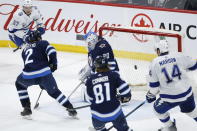 Winnipeg Jets goaltender Laurent Brossoit (30) cannot stop a rebound shot from Tampa Bay Lightning's Alex Killorn (not shown) to give them a in third-period NHL hockey game action in Winnipeg, Manitoba, Friday, Jan. 17, 2020. (John Woods/The Canadian Press via AP)