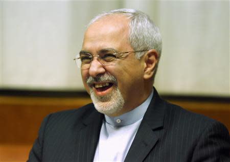 Iranian Foreign Minister Mohammad Javad Zarif smiles at a plenary meeting at the start of three days of closed-door nuclear talks at the United Nations European headquarters in Geneva November 20, 2013. REUTERS/Denis Balibouse