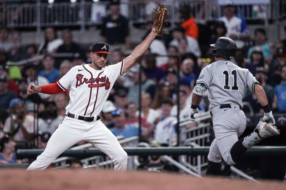 New York Yankees' Anthony Volpe (11) is put out at first base by Atlanta Braves first baseman Matt Olson on a grounder during the seventh inning of a baseball game Wednesday, Aug. 16, 2023, in Atlanta. (AP Photo/John Bazemore)
