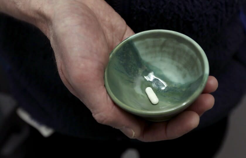 SANTA MONICA, CA - FEBRUARY 24, 2022 - - Dr. Keith Heinzerling, director of Treatment & Research in Psychedelics, holds a ceramic bowl containing one psilocybin pill that will be used by patient M to treat her alcoholism as part of a study at the Pacific Neuroscience Institute in Santa Monica on February 24, 2022. The patient is allowed to keep the bowl as a memento of the experience. The Pacific Neuroscience Institute has been exploring in a study the use of psilocybin in therapy. The study, which recruited participants with alcohol use disorder, is gauging the tolerability and effectiveness of playing an immersive video of nature scenes as the psilocybin session begins. (Genaro Molina / Los Angeles Times)