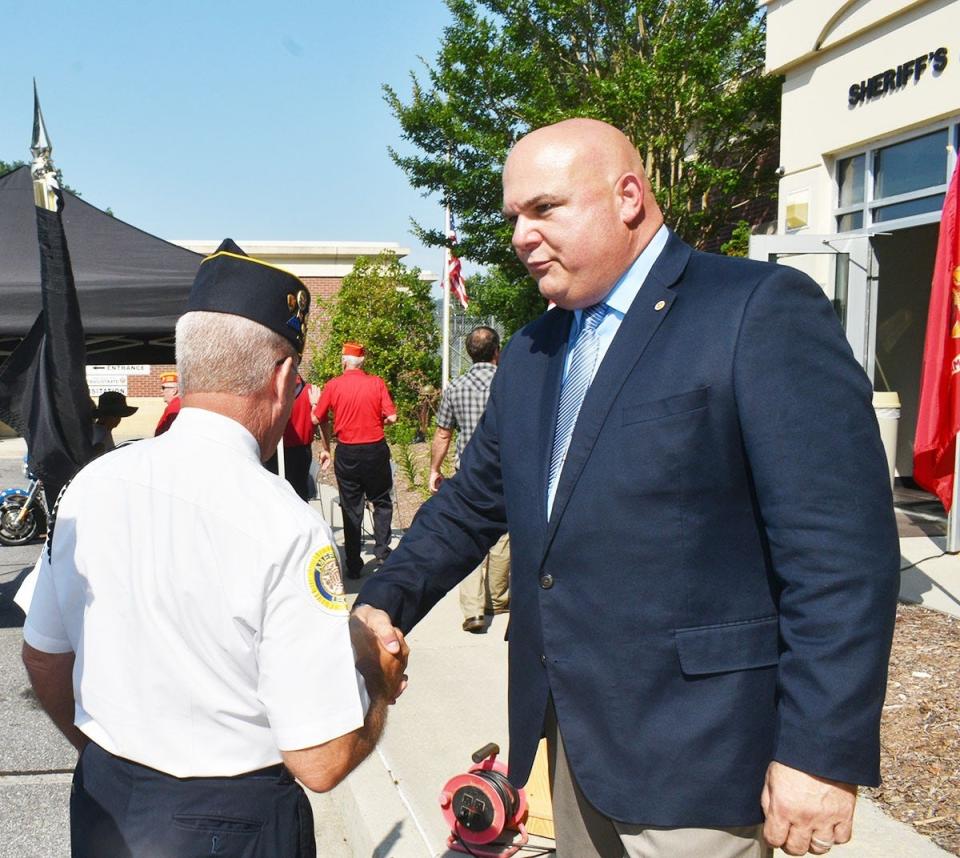 Clay County Chief Deputy Todd Wingate shakes hands with an American Legion member after a memorial service on July 27, 2023 for veteran Marine Lance Corporal Sean Willey who died in Clay County while hiking the Appalachian trail. He disappeared in March 2022 and his remains were found in November of that year. The day after the memorial service, Wingate, Clay County Officer Ethan Henderson and a changing motorcade of veterans on motorcycles escorted Willey's remains home to Ilion where he moved after growing up in Utica.