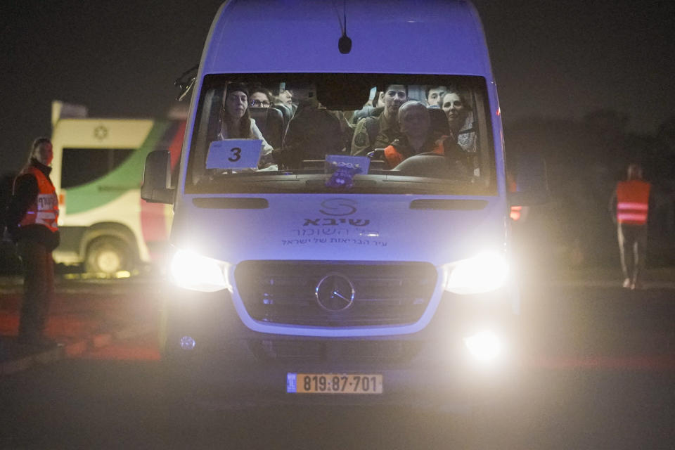 A mini-bus carrying Israeli hostages released by Hamas and Israeli military personnel arrives at the Sheba Medical Center in Ramat Gan, Israel, early Thursday, Nov. 30, 2023. International mediators on Wednesday worked to extend the truce in Gaza, encouraging Hamas militants to keep freeing hostages in exchange for the release of Palestinian prisoners and further relief from Israel's air and ground offensive.(AP Photo/Leo Correa)