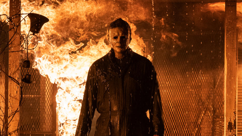 Michael Myers, character in Halloween, stands in front of a raging fire 