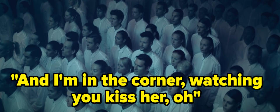 Still from the music video with the lyric: "And I'm in the corner, watching you kiss her, oh"