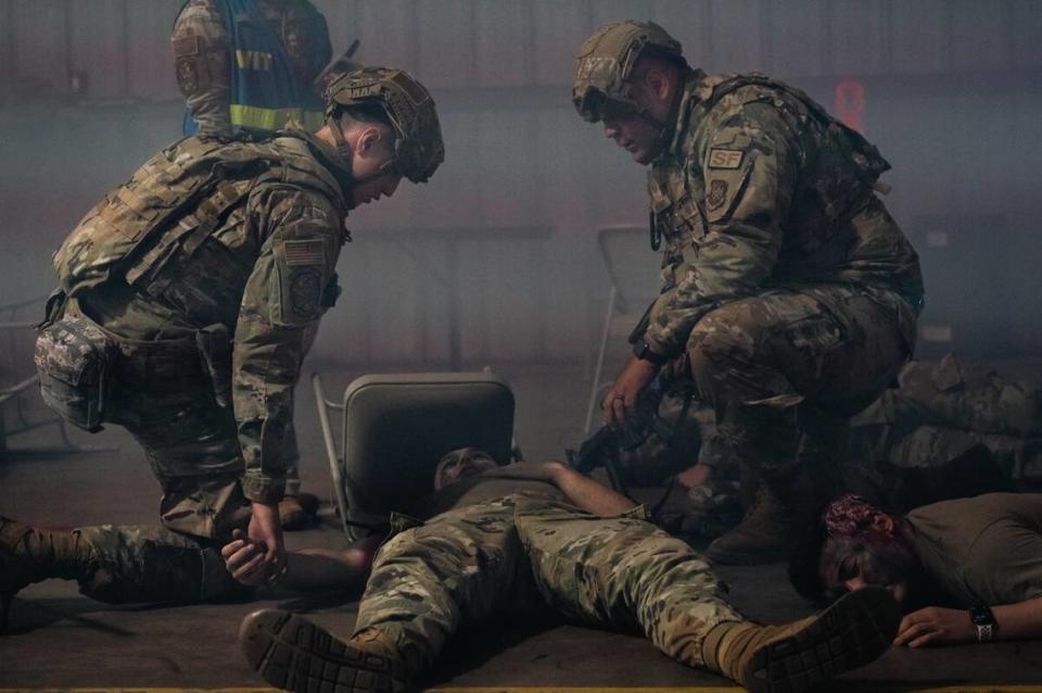 Airmen from the 375th Security Forces Squadron make an initial assessment of a casualty after a simulated explosion during the Belligerent Badger 23 exercise April 17 on Volk Field Air National Guard Base, Wisconsin. Airmen were tested on their ability to administer Tactical Combat Casualty Care.