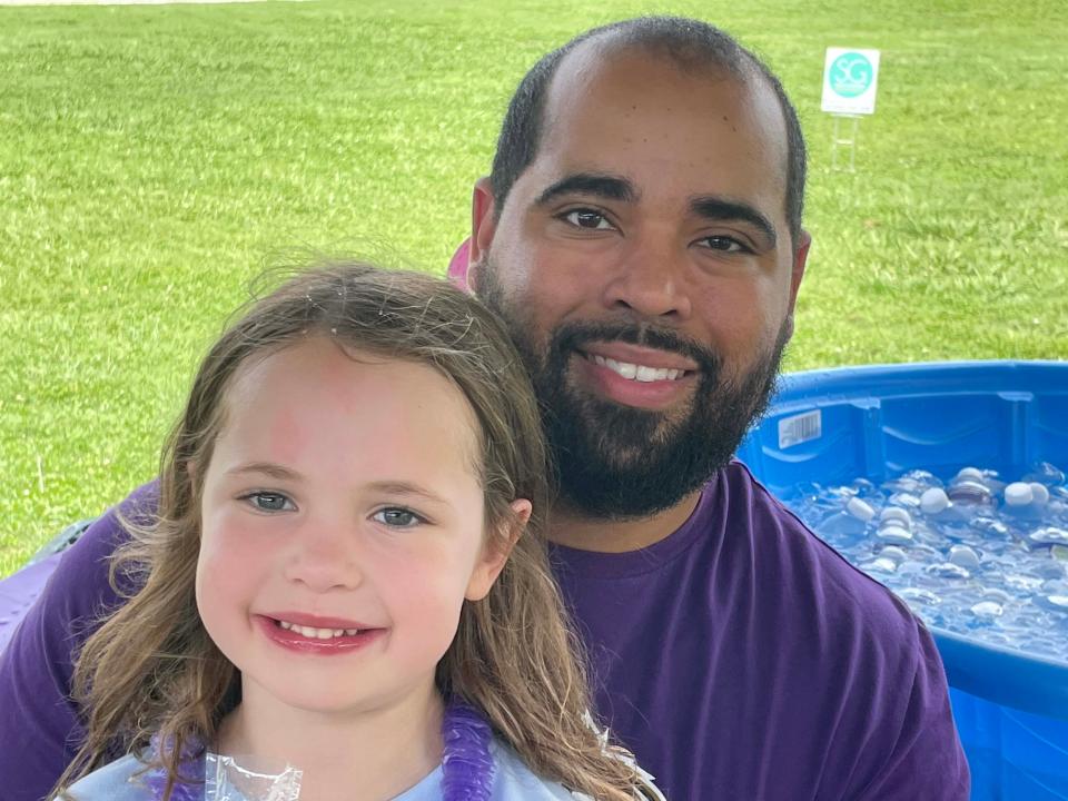 Aivyn McCormick is sticking close to dad DJ McCormick, who said it’s important for dads to be a part of the child’s school life, at the annual Hardin Valley Elementary School Popsicle Party held at the school Sunday, Aug. 14, 2022.