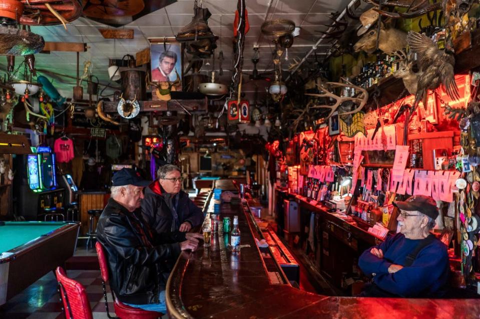 Mike Guzek, left, 81, of Ontonagon, and John Harris, center, 65, of Ontonagon, talk with Stubb's Museum Bar owner Elmer Marks, 82, of Ontonagon, on Thursday, Oct. 20, 2022.